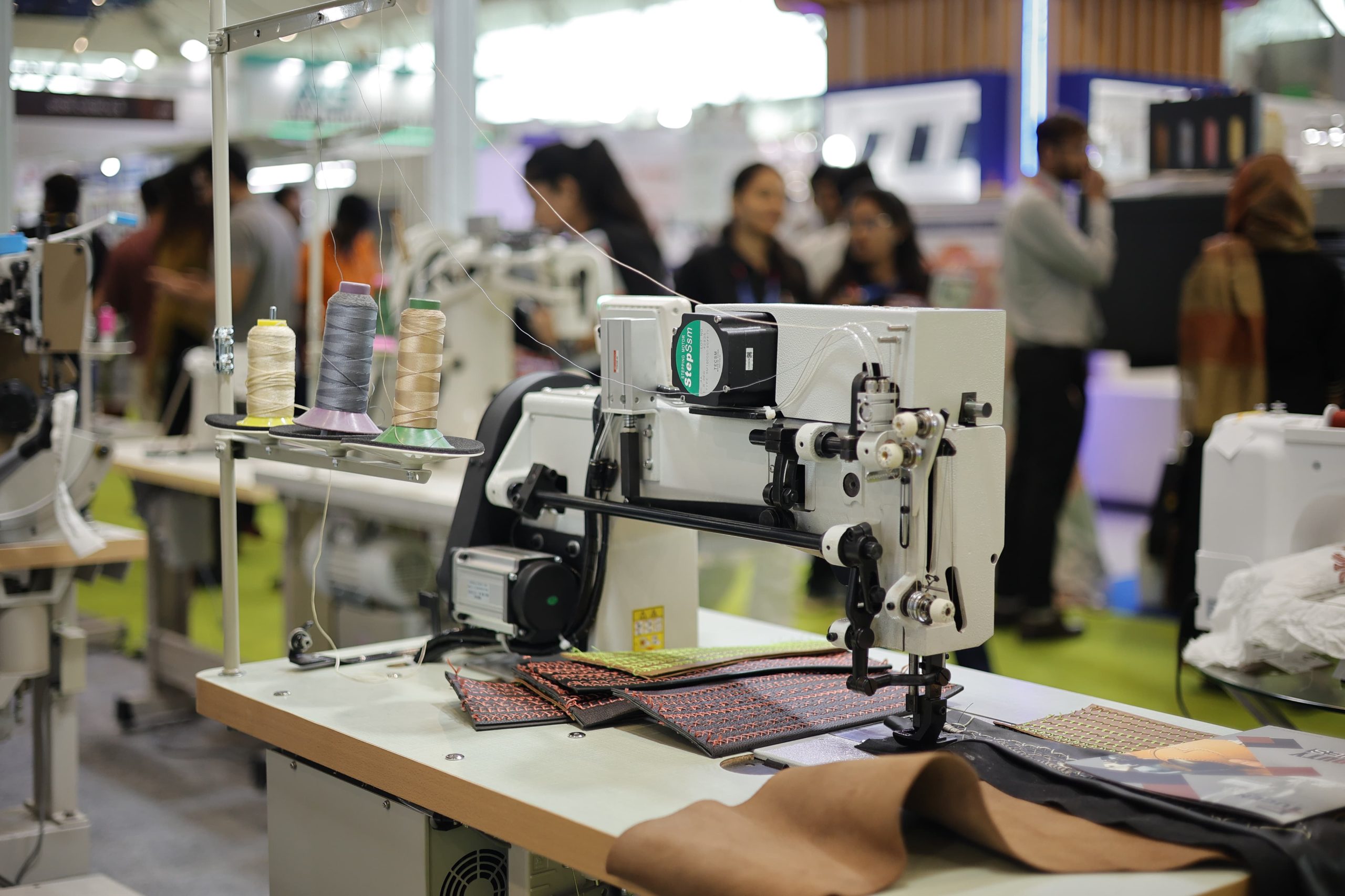 Garment factory workers using modern stitching and finishing machines